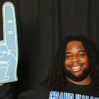 student posing with the foam finger